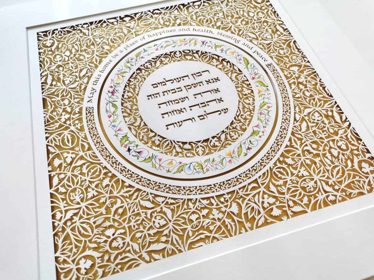 Jewish Home Blessing papercut artwork with intricate floral pattern over gold background