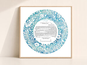 Circular Wildflower Ketubah displayed on an easel in a floral garden setting